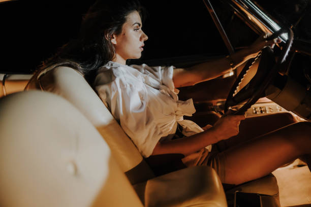 istock Young woman driving her car overtired during nighttime 1359672053
