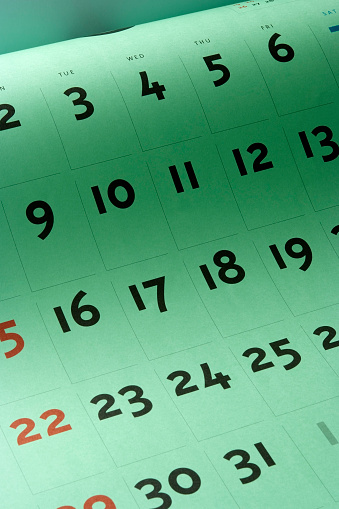 High angle view of opened blank green calendar.