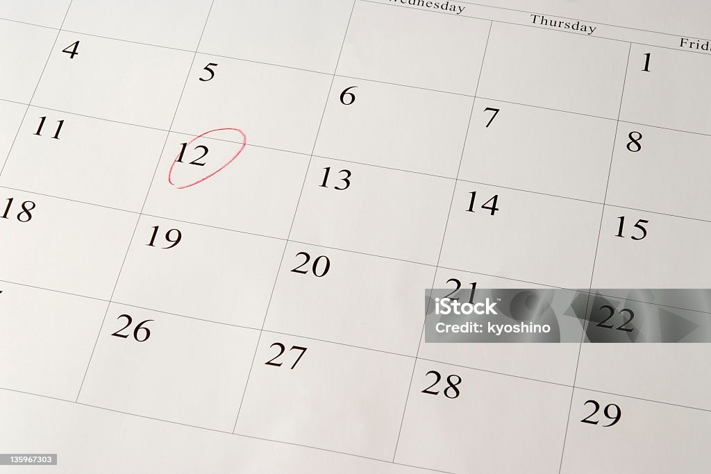 Setting a date on calendar by red pen Close-up of setting a date on calendar by red pen. Calendar Stock Photo