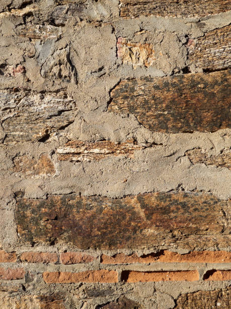 istock Rustic rough brown and red background.  Textured wall made with a mix of materials: Stone, cement and brick 1359674607