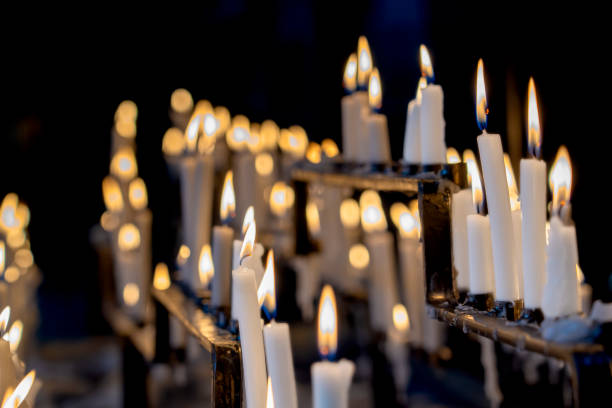 istock Religion background with burning white candles on fireplace at Church 1359676854