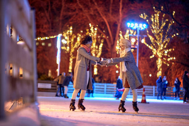 happy friends on skating rink.woman have fun in a ice arena happy friends on skating rink.Smiling woman have fun in a ice arena ice skating photos stock pictures, royalty-free photos & images