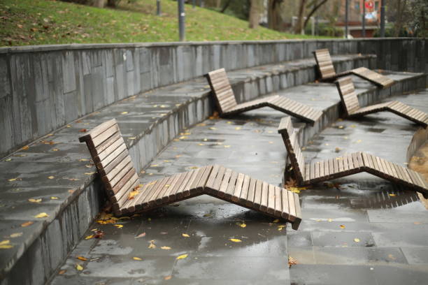 istock Wooden sunbed bed sunbathn on city park rainy winter day 1359680708