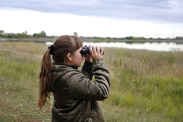 istock girl looks in binoculars 135968157