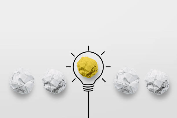 istock Paper scrap ball yellow color outstanding different group with light bulb symbol. Great idea concept. 1359682104