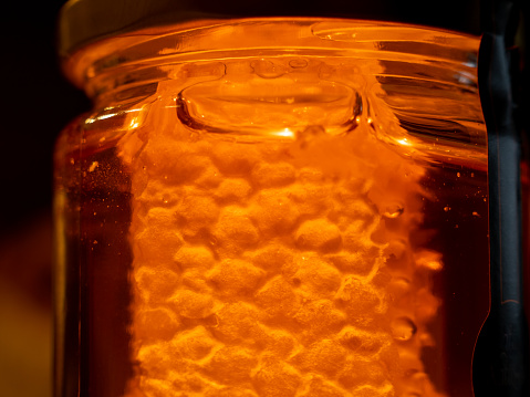 jar of honey with honeycombs.