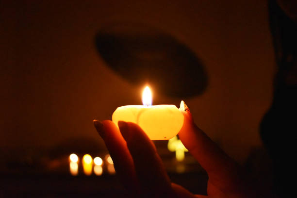 istock hand holding candle by candlelight 1359686274