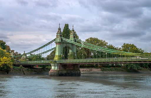 View of Hammersmith Bridge, a Grade II listed suspension bridge that crosses the River Thames, connecting Hammersmith to Barnes, in west London.