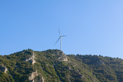 Wind generator at the mountain . Windmill on the peak