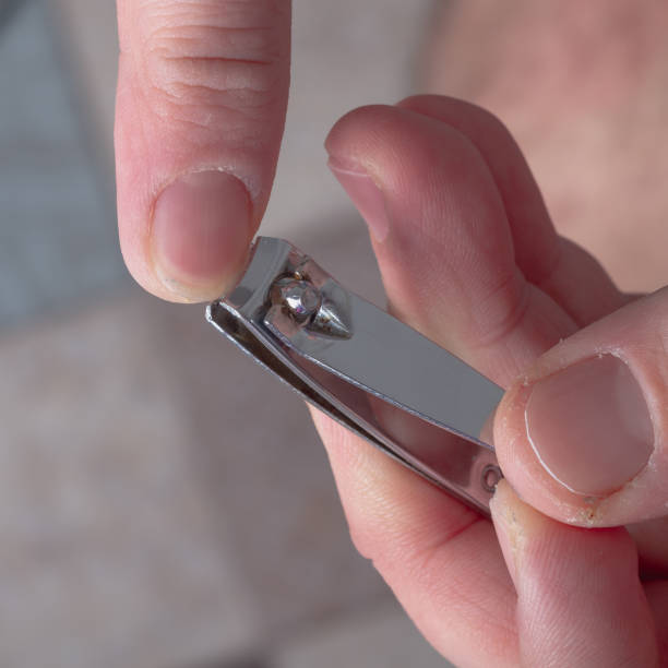 istock A man cuts his fingernails with nail clippers, a man's manicure on his own 1359688300