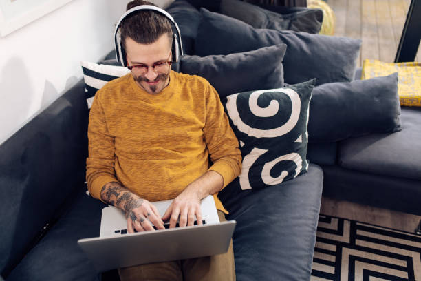 istock Happy freelancer enjoying on the sofa and working 1359688934