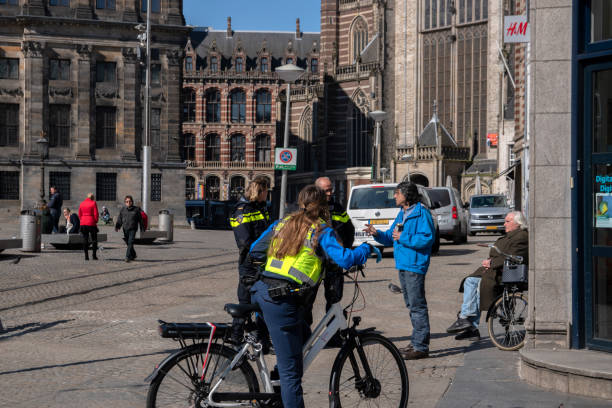 Police Talks With Homeless During The Corona Virus Outbreak At Amsterdam The Netherlands Police Talks With Homeless During The Corona Virus Outbreak At Amsterdam The Netherlands 2020 boa stock pictures, royalty-free photos & images