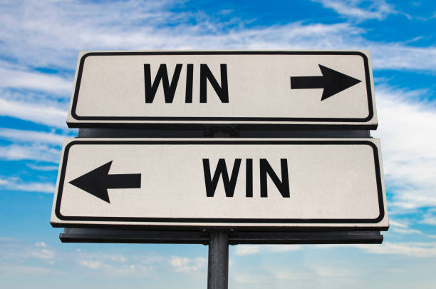 istock Win win road sign with two arrows on blue and grey sky background. 1359690317