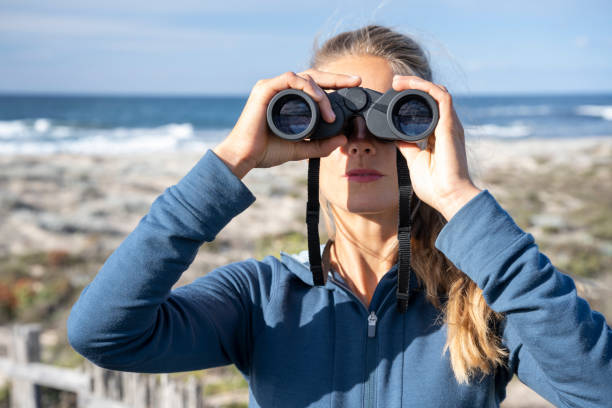 istock Woman looking through Binoculars on Safari 1359691437