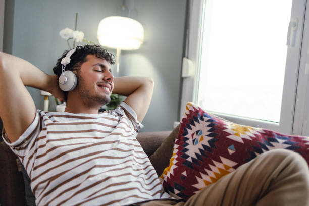 istock Young man relaxing at home 1359694897