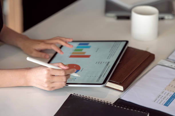 istock woman hand working on portable tablet with business graph. 1359695147