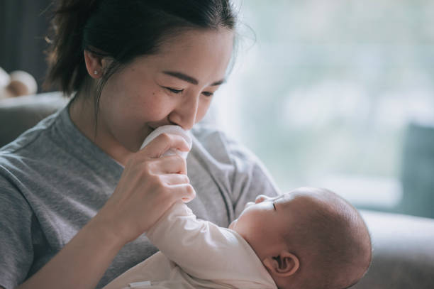 asian chinese mother bonding time with her baby boy toddler at home - baby carrier fotos imagens e fotografias de stock
