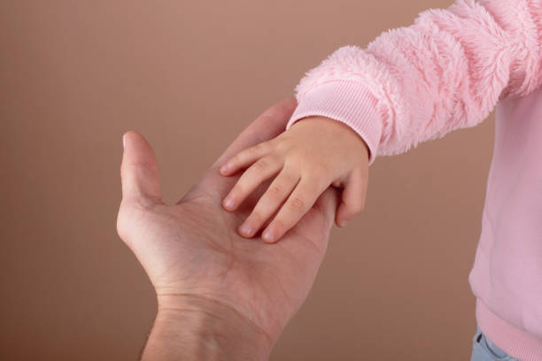 istock Dad holds his little daughter by the hand 1359696379