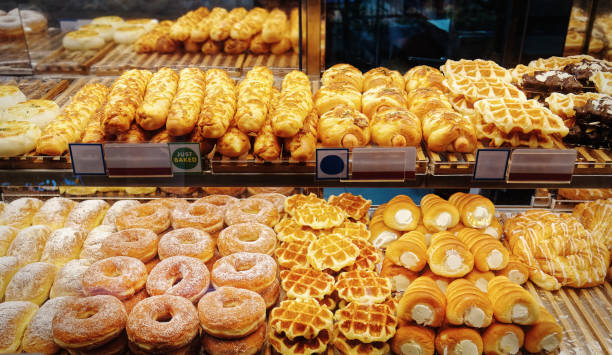 istock Various Kinds of Freshly Baked Bread and Donuts at Retailed Bakery Display 1359696393