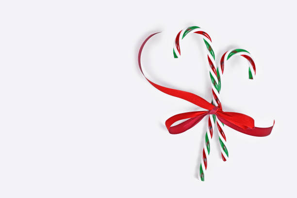 istock Striped candy canes tied together with red ribbon 1359697405