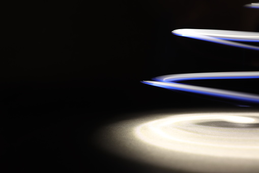 Light Painting is a form of art that capture the motion of a light. This photo capture a beautiful blue and white light in a motion created with a black dark background
