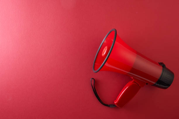 istock megaphone on red color background. Advertisement, announcement message. 1359713024