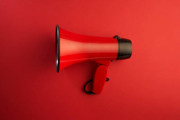 istock megaphone on red color background. Advertisement, announcement message. 1359713025