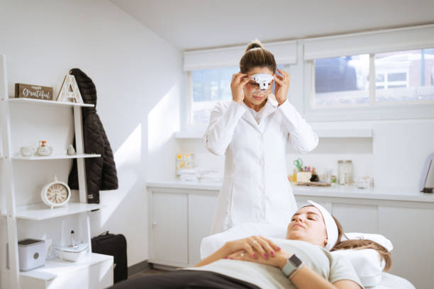 istock Female dermatologist performing a procedure on a client 1359714136