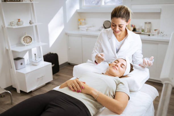 istock Female dermatologist performing a procedure on a client 1359714172