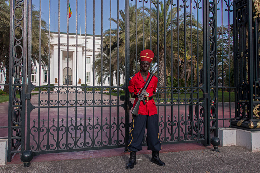 Dakar, Senegal - May 27, 2014: Soldier standing guard at the main gate of the presidential palace