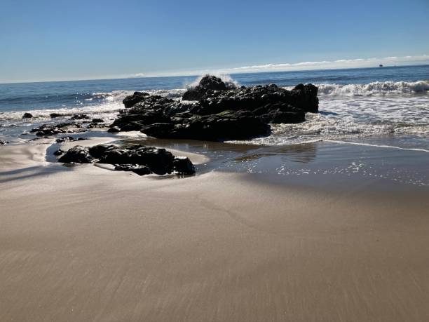istock More Waves crash on the tide pool on a sunny day 1359715314