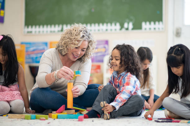 istock Preschool Teacher Helping a Student 1359715986