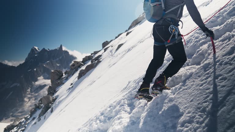 Team of climbers moving up the peak. Winter adventure