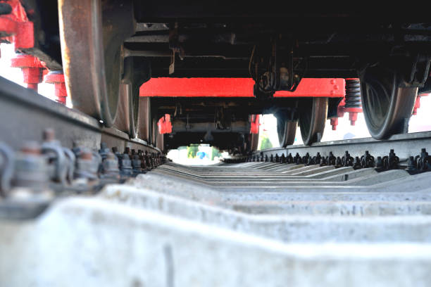 vieille locomotive de chemin de fer, vue du bas, debout sur des rails - underbelly photos et images de collection