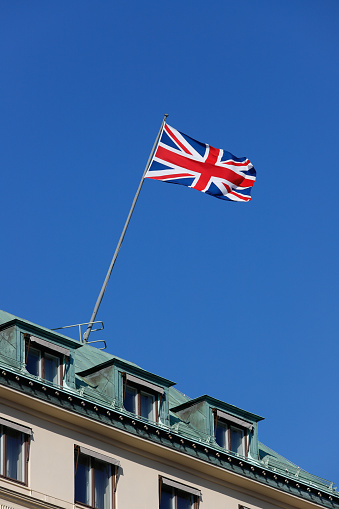 Low angle view of the British flag hoisted on a roof top.