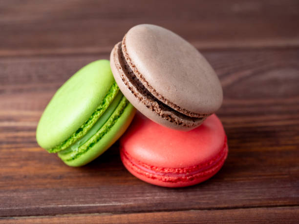 istock three macaroons on a wooden background. Side view. Delicious sweet dessert 1359727558