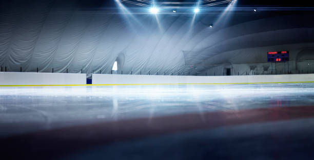 Hockey stadium. Realistic background. Reflection. Beautiful empty winter background and empty ice rink with lights. Spotlight shines on the rink