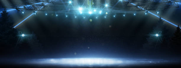 istock Background. Beautiful empty winter background with lights. Spotlight shines on the rink. Bright lighting with spotlights. Christmas trees on ice 1359731638