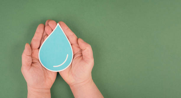 istock Hands holding a drop of water, paper cut out, environmental issue, copy space for text 1359733264
