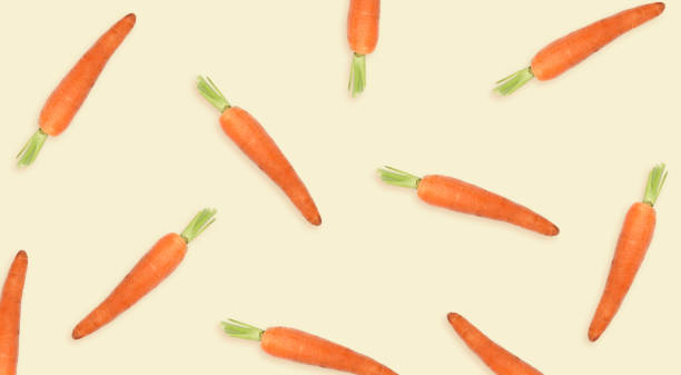 istock Whole carrots on beige background, banner. Pattern design 1359735150