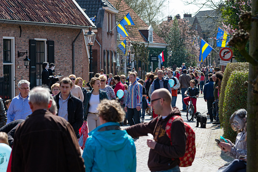 Borne, Twente, Overijssel, Netherlands, april 21st 2013, a crowded street in the old town of Borne at the annual Living Statues event where people can admire different acts of performers posing as a statue on a route through part the town