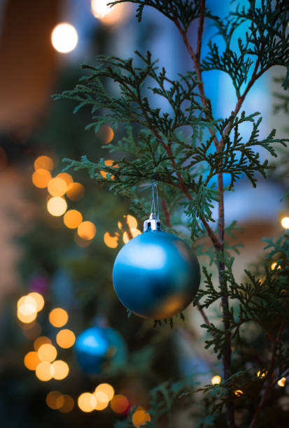 istock Vivid Christmas decorations on the pine tree branch closeup 1359741076