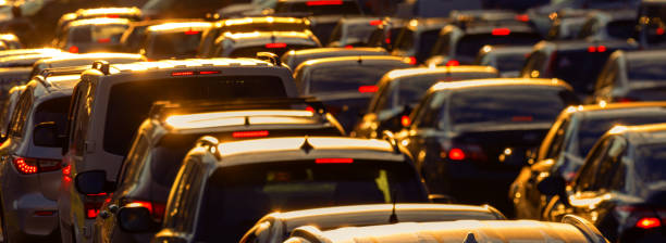 Car traffic jam at sunset selective focus. Heavy traffic jam during rush hour at sunset or dawn. traffic stock pictures, royalty-free photos & images