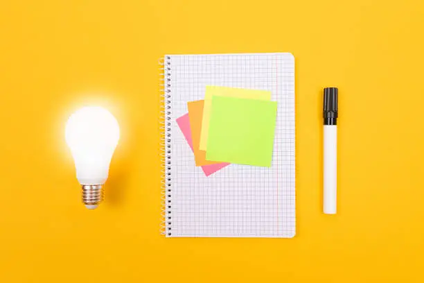 Photo of Glowing Power Saving Lamp and Notepad with Sticky Notes