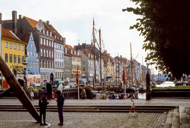 Copenhagen, Denmark - aug 04, 1987: historic houses line the Nyhavn canal harbor in Copenhagen, one of the most famous and atmospheric areas of the Hanseatic city.