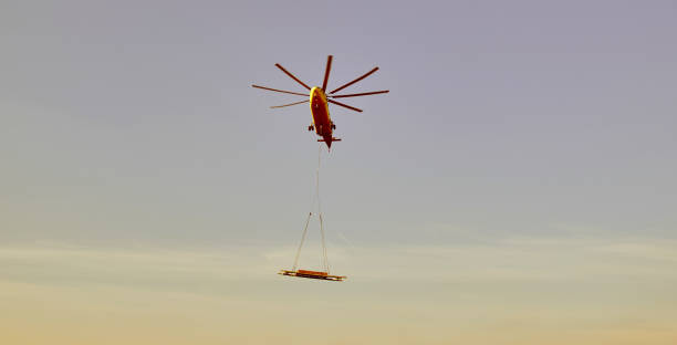 istock The world's largest cargo helicopter hovers overhead. Bottom view.The world's largest cargo helicopter transports cargo on a wire rope. Bottom view 1359744977