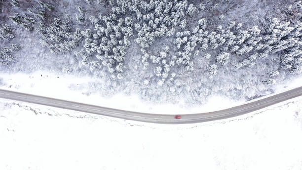 istock Car driving on winter country road 1359746667