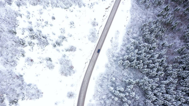 istock Car driving on winter country road 1359746674