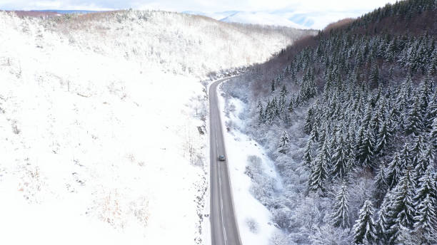 istock Car driving on winter country road 1359746692