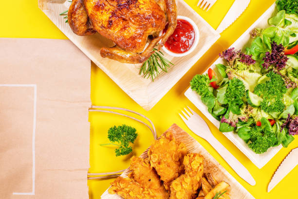 istock Chicken roast ,vegetables in cardboard plate take away container colored yellow background.Food delivery service. Roast chicken delivery tasty food.Hot meal take away service to home in a restaurant. 1359748537